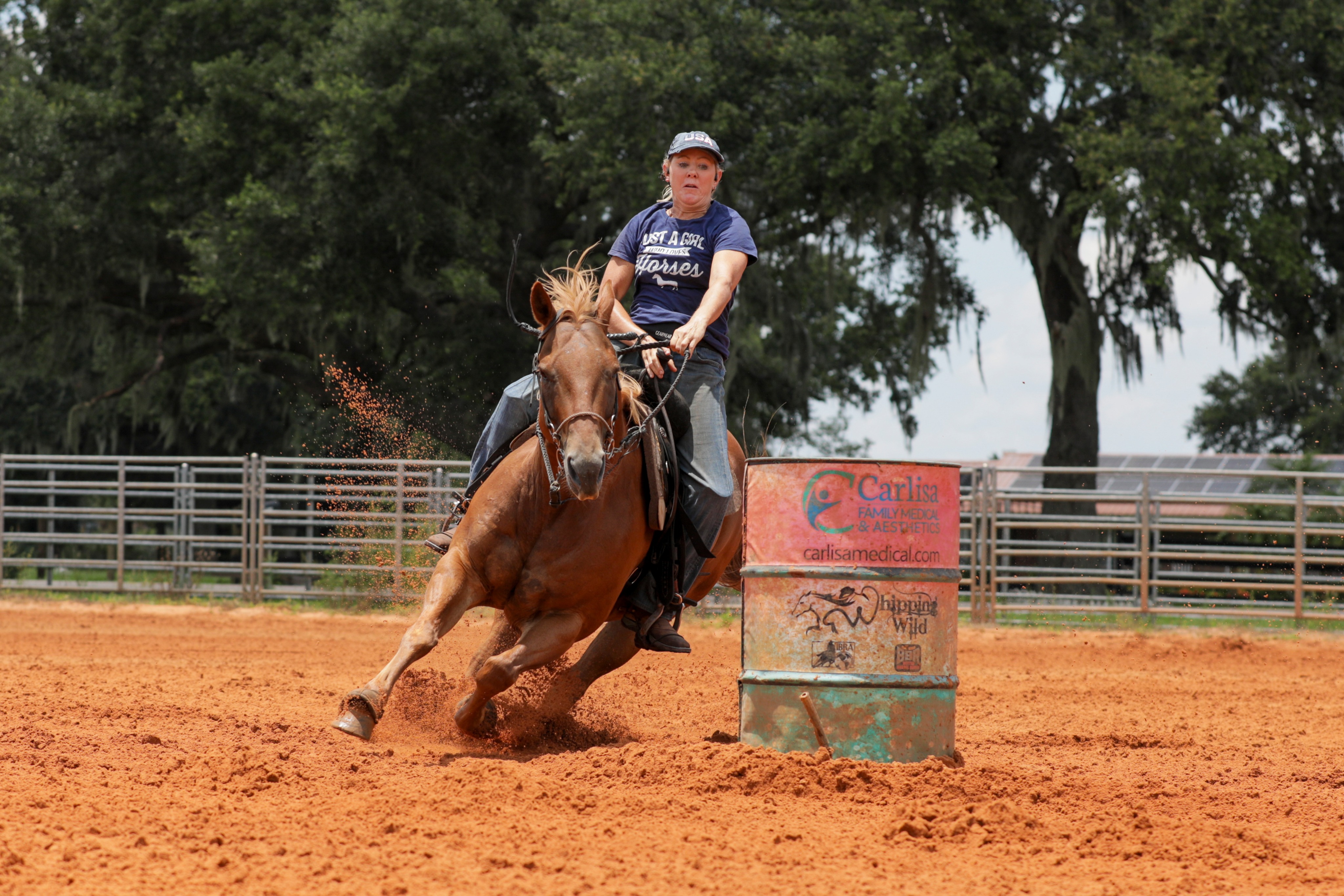 Kathy Dickason riding Smoke to win the 1D for 2022. The image shows Kathy and Smoke turning the barrel with little room to spare.